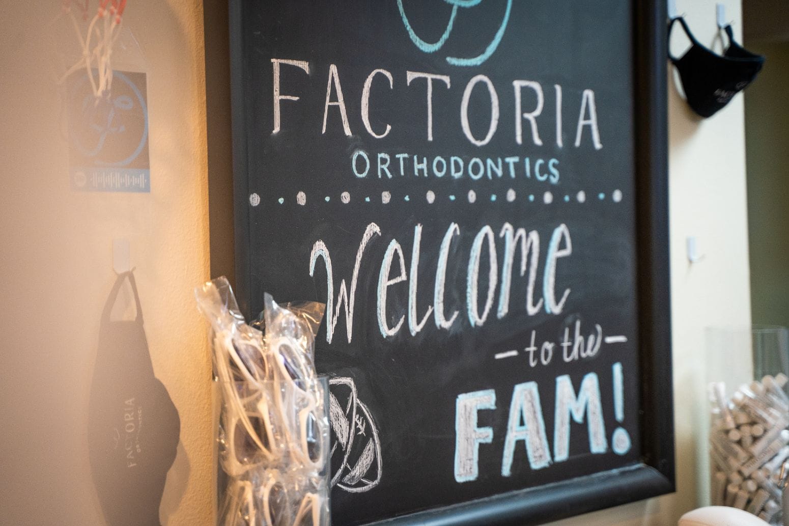 A sign that says factoria orthodontics welcome to the fam.