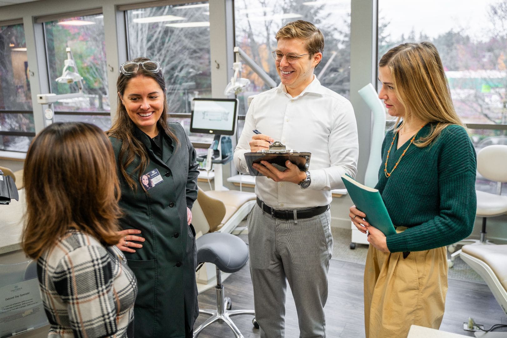 Dr. Adam and team members having a conversation with a patient.