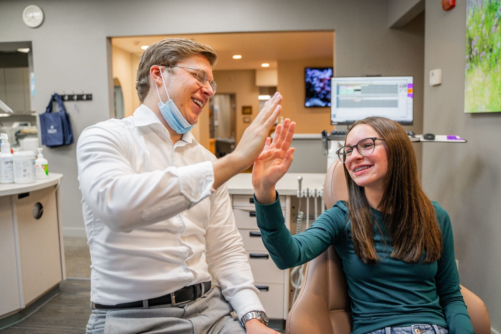 Dr. Adam giving a high five to a patient.