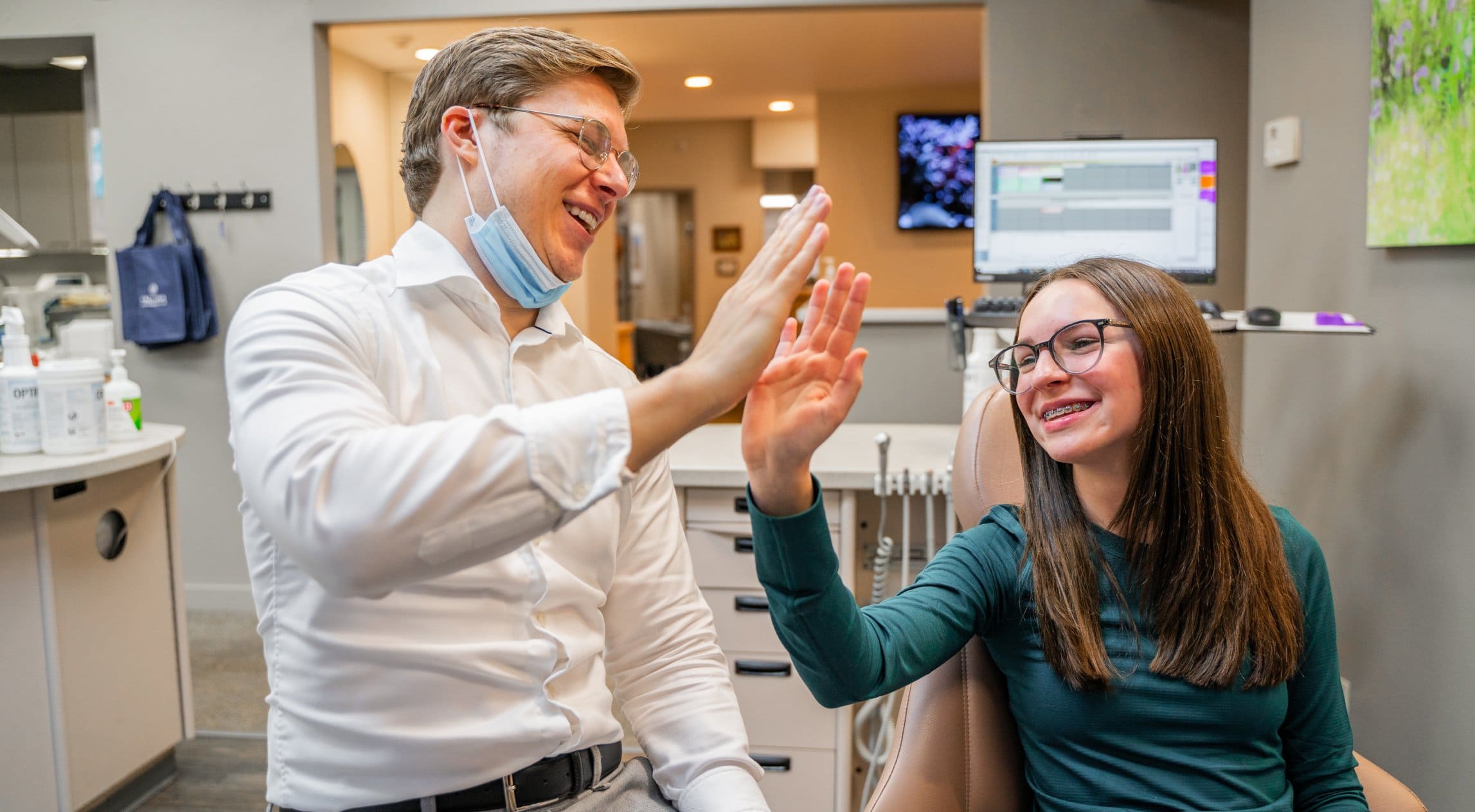 Dr. Adam and teen patient high fiving