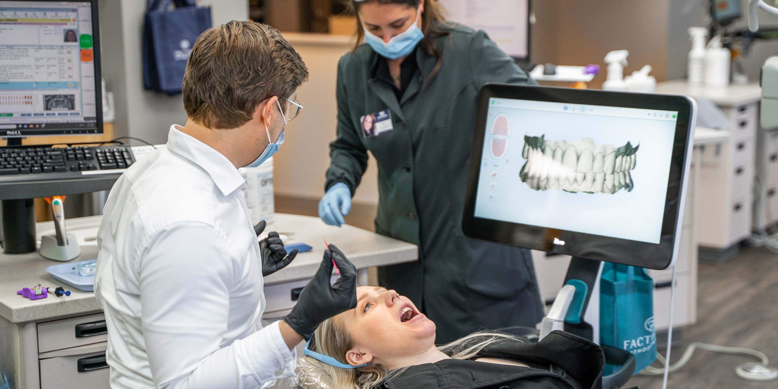 A dentist is working on a patient in a dental office.